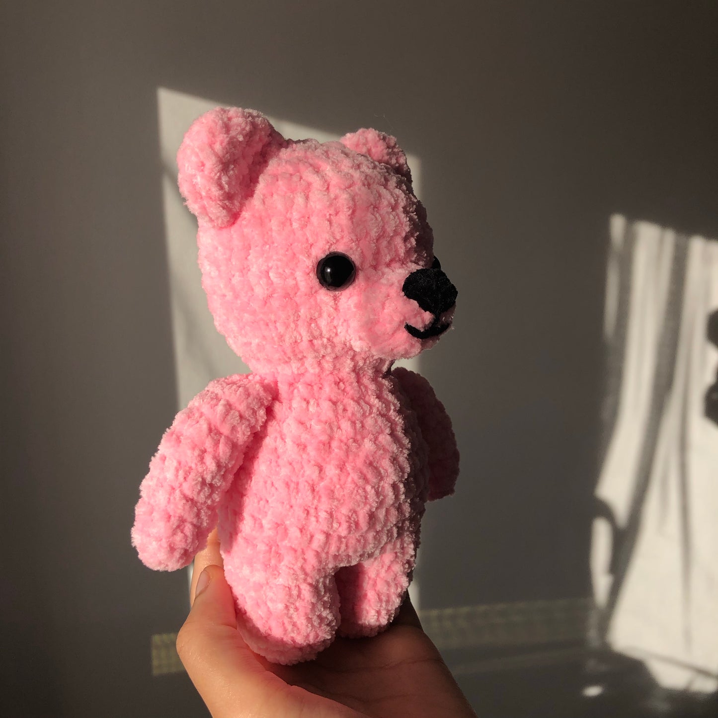pink bear facing the right